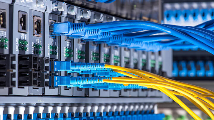 Blue and yellow network cables plugged into a server interface