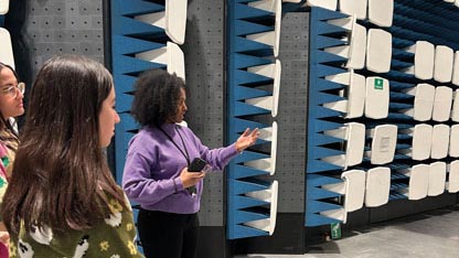 Young women listening to guide inside test chamber