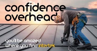 Man with construction tool working on the roof of a building