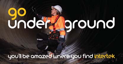 Engineer performing an inspection inside a large man-made tunnel